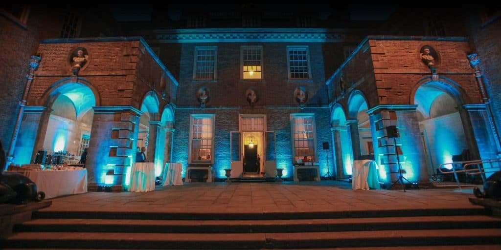 Turquoise light illuminates a building exterior