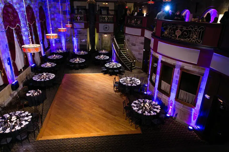 Purple light frames a ballroom viewed from above