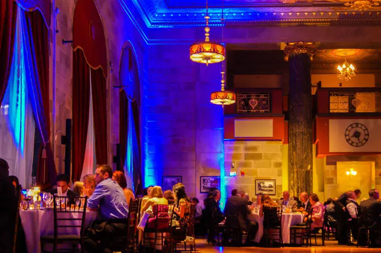Blue-lit columns beside warm golden walls