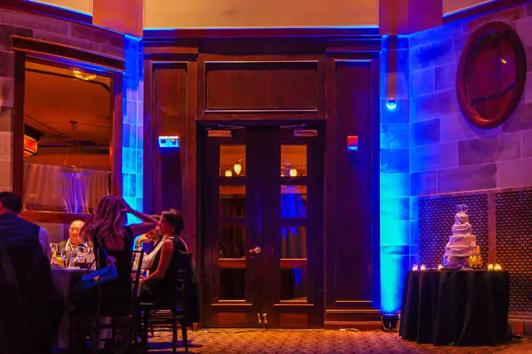 Blue uplighting emphasizes tall decorative columns