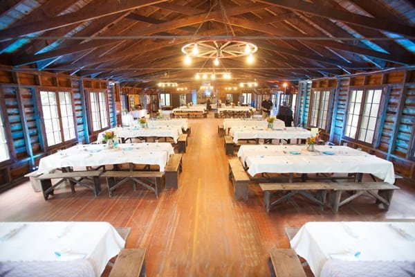 Blue light accents the rafters of a rustic barn