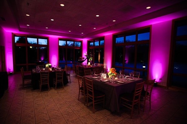 Magenta uplighting around a reception room